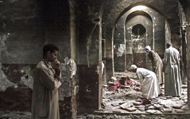 Egyptian Christian villagers cleaned up the damaged ancient chapel inside the Virgin Mary and St. Abraam Monastery that was looted and burned by Islamists in Dalga, Minya province, Egypt, in 2013