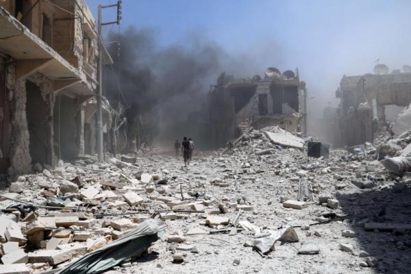 Peace - Rubble covers the street following an alleged airstrike by a Syrian army helicopter in the northern city of Aleppo on June 11