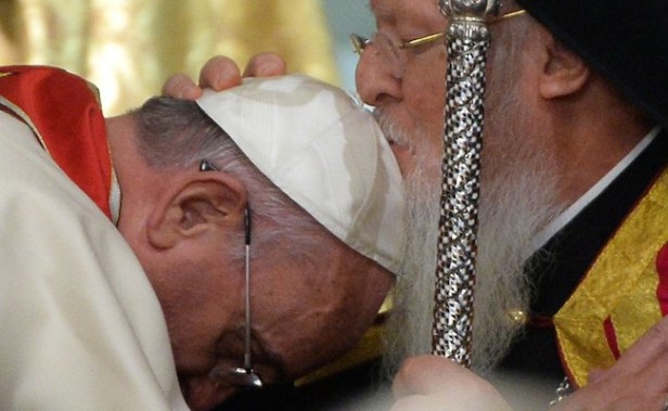 Ecumenical Patriarch Bartholomew I of Constantinople kisses the head of Pope Francis during a ceremony at the St George church, the principal Greek Orthodox cathedral, on November 29, 2014 in Istanbul as part of a three day visit in Turkey. In a highly symbolic gesture, the pope asked Bartholomew to kiss his brow in a blessing and bowed his head to show humility. Francis and Bartholomew -- who enjoy warm relations -- are working to narrow the differences between the two Churches that date back to the great schism of 1054 that split the eastern and western Christian Churches. AFP PHOTO / FILIPPO MONTEFORTE