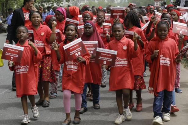 Young girls known as Chibok Ambassadors, carry placards bearing the names of the girls kidnapped from the government secondary school in Chibok, a year ago, during a demonstration, in Abuja, Nigeria, Tuesday, April 14, 2015. Never to be forgotten. The new slogan adopted Tuesday is a sad concession that many believe few of the Chibok girls kidnapped one year ago by Islamic extremists will ever find their way home. On the first anniversary of the day 276 schoolgirls were snatched in the middle of the night as they prepared to write science exams at their boarding school in northeastern Nigeria, President-elect Muhammadu Buhari said he cannot promise to find the 219 who are still missing. (ANSA/AP Photo/Sunday Alamba)