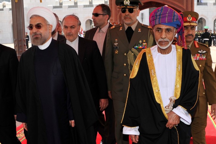Oman's Sultan Qaboos bin Said walks with Iran's President Hassan Rouhani upon Rouhani's arrival in Muscat